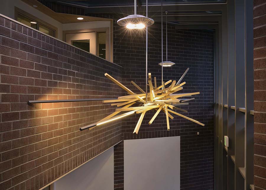 The nest pendant resembles the nest of a bird using large wooden dowels inlaid with LED lights